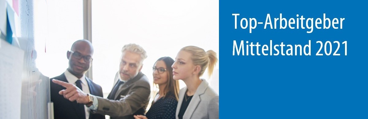 Diverse group of office workers strategizing together on a whiteboard